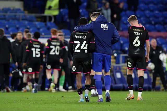 Bali Mumba of Peterborough United is consoled by Jordan Hugill of Cardiff City at full-time. Both are Norwich City players currently out on loan. Photo: Joe Dent/theposh.com.