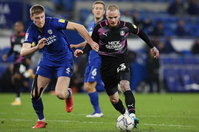 Joe Ward of Peterborough United takes on Mark McGuinness of Cardiff City. Photo: Joe Dent/theposh.com.