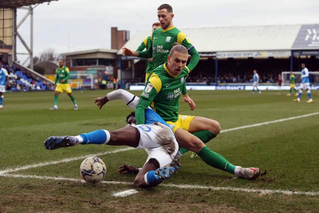 Kwame Poku of Peterborough United battles with Brad Potts of Preston North End. Photo: Joe Dent/theposh.com.