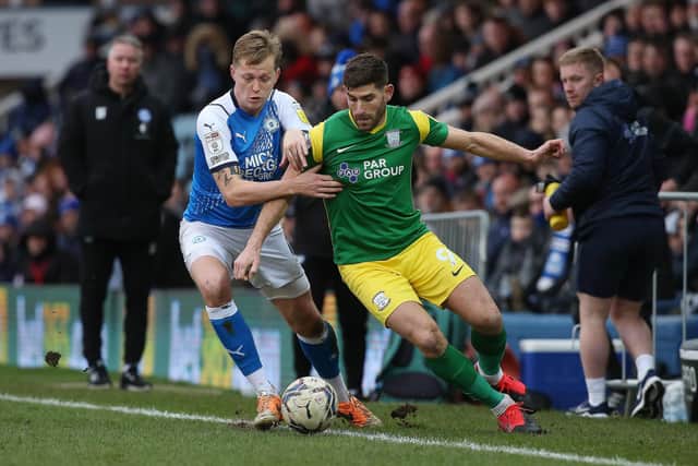 Frankie Kent of Peterborough United battles with Ched Evans of Preston North End. Photo: Joe Dent/theposh.com.