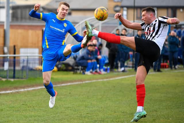 Dan Jarvis (blue) in action for Peterborough Sports against Coalville.