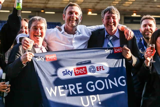 Posh co-owners, from left, Stewart 'Randy' Thompson, Darragh MacAnthony and Dr Jason Neale celebrate promotion from League One last season.