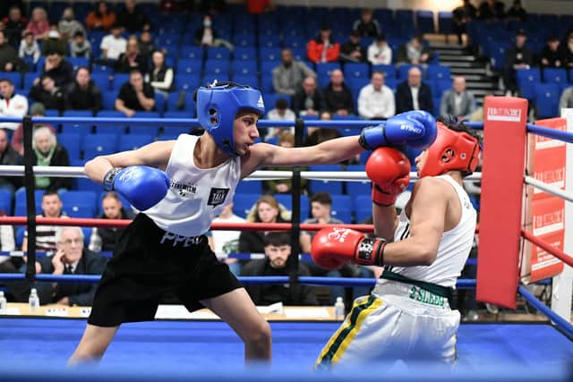 Mohammed Ismaael (blue headgear) in action for the Police club. Photo: David Lowndes.
