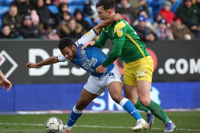 Nathan Thompson (blue) in action for Posh against Preston, Photo: Joe Dent/theposh.com.