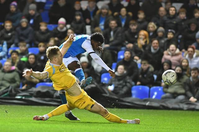 Posh forward Kwame Poku crosses the ball under pressure against Reading. Photo: David Lowndes.