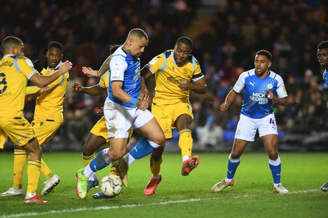 Posh striker Jonson Clarke-Harris can't get the ball out from under his feet in the game against Reading. Photo: David Lowndes.