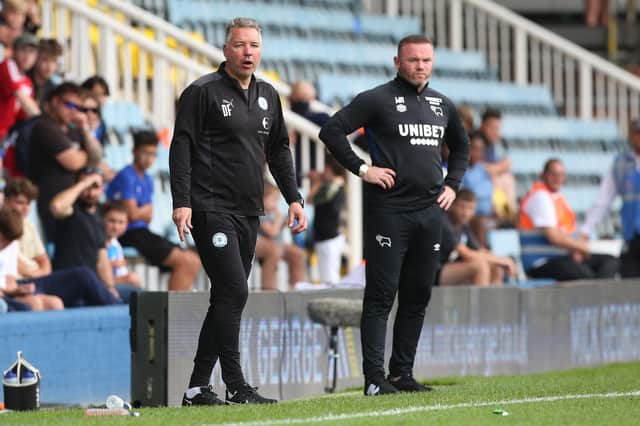 Peterborough United Manager Darren Ferguson (left) on the touchline alongside Derby County manager Wayne Rooney at London Road in August.