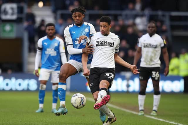 Ricky-Jade Jones of Peterborough United puts pressure on Curtis Davies of Derby County. Photo: Joe Dent/theposh.com.