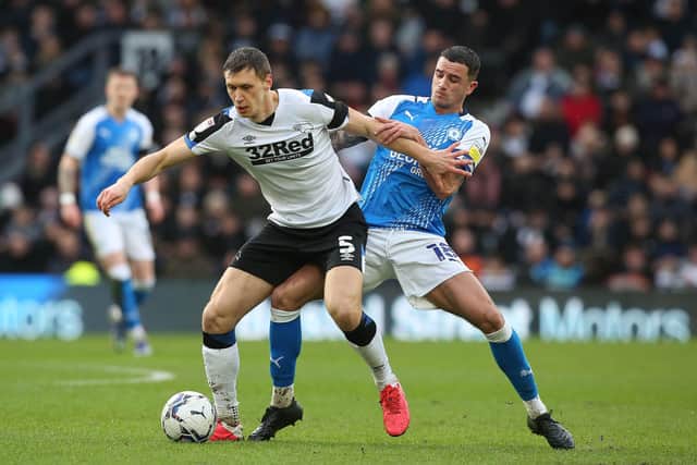 Oliver Norburn of Peterborough United battles with Krystian Bielik of Derby County. Photo: Joe Dent/theposh.com.