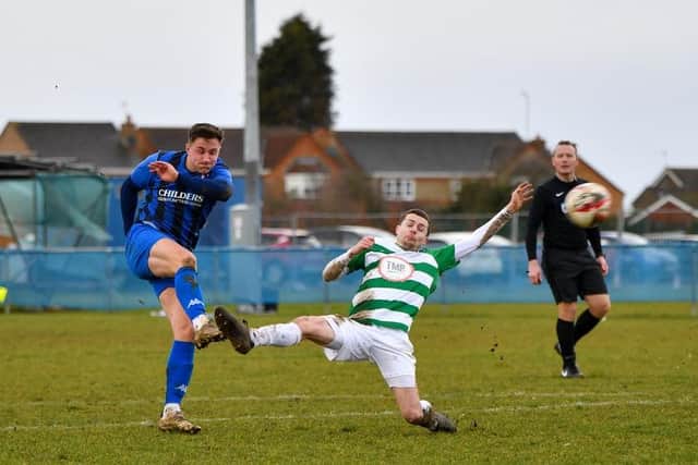 Ben Cowles (blue) of Whittlesey Athletic lets fly at the Framlingham goal. Photo: James Richardson.