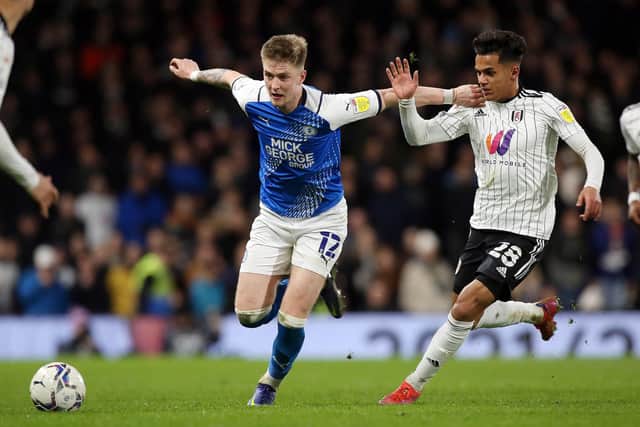 Josh Knight of Peterborough United battles with Fabio Carvalho of Fulham. Photo: Joe Dent/theposh.com.