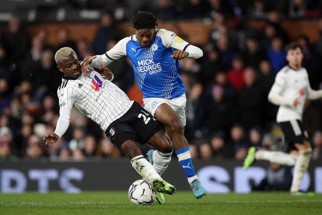 Ricky-Jade Jones of Peterborough United in action with Jean Michael Seri of Fulham. Photo: Joe Dent/theposh.com