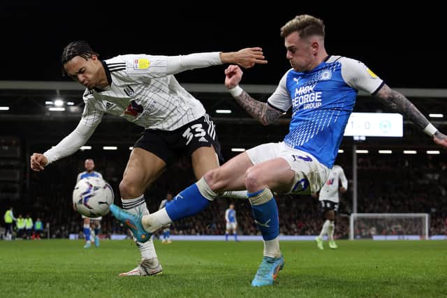 Sammie Szmodics of Peterborough United in action with Antonee Robinson of Fulham. Photo: Joe Dent/theposh.com.
