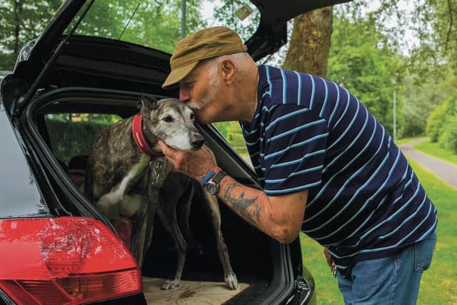 Tom Brazier pictured by Peterborough street photographer Chris Porsz with his beloved greyhound Dee.