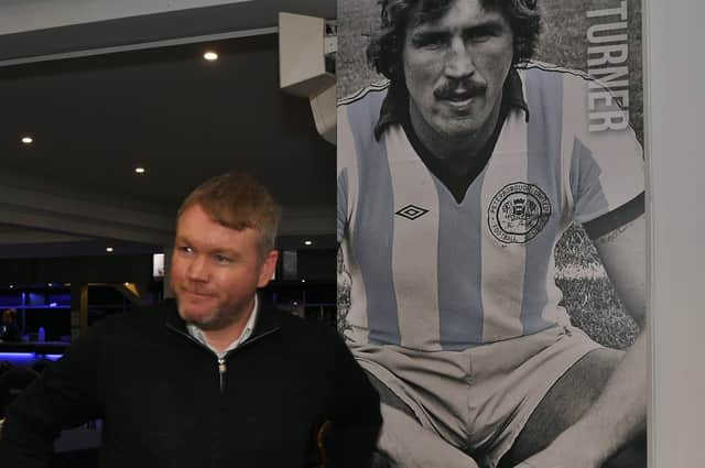New Posh boss Grant McCann pictured in front of one of the club's managerial greats Chris Turner. Photo: David Lowndes.