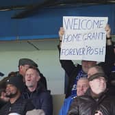 A Peterborough United supporter shows a signing welcoming new manager Grant McCann back to London Road. Photo: Joe Dent/theposh.com.