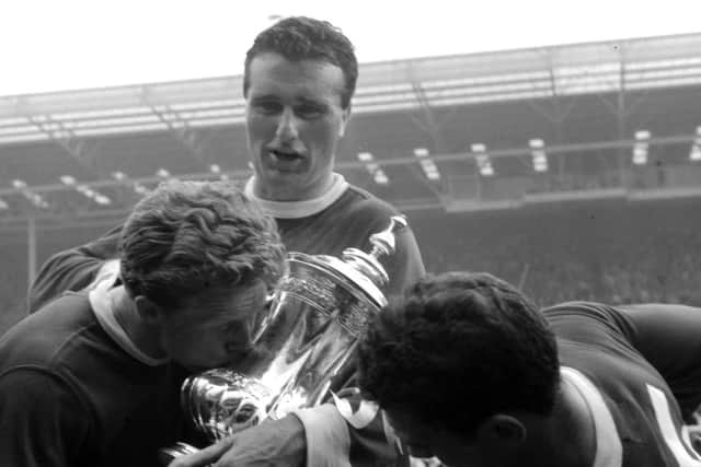 Manchester United skipper Noel Cantwell (centre) with the FA Cup after a 1963 final success.