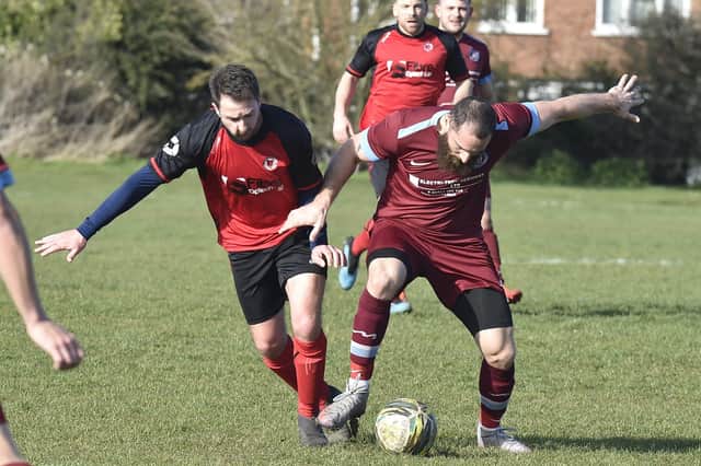 Chris Down (right) of Thorpe Wood Rangers battles for possession against Netherton A. Photo: David Lowndes.