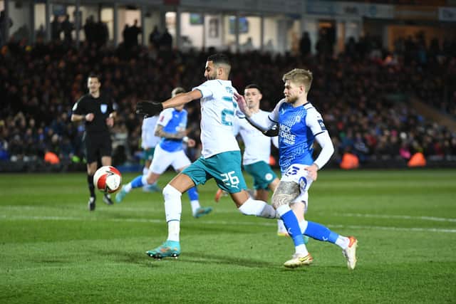 Posh wingback Hayden Coulson chases Manchester City star Riyad Mahrez. Photo: David Lowndes.