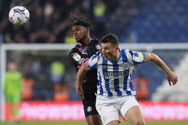 Ricky-Jade Jones of Peterborough United puts pressure on Matty Pearson of Huddersfield Town. Photo: Joe Dent/theposh.com.