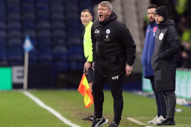 Peterborough United manager Grant McCann shouts instructions from the touchline during the game at Huddersfield.