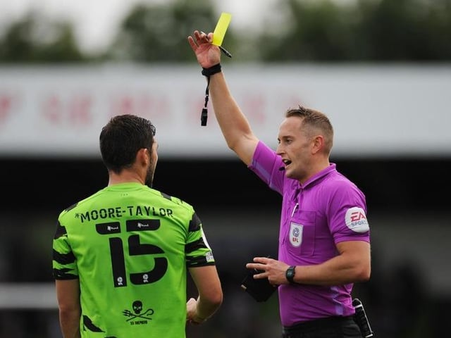 James Bell shows a yellow card to Jordan Moore-Taylor. The leaders have had 46 yellow cards and one double booking this season.
Photo: Getty Images