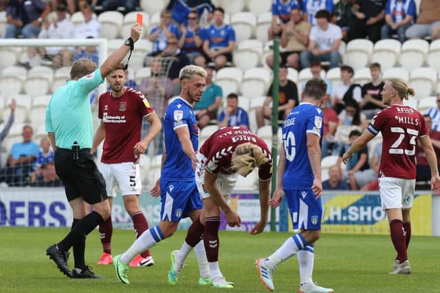 Referee Trevor Kettle shows a straight red card to Fraser Horsfall against Colchester United at the beginning of this season, but where do Northampton Town stand in the dirtiest team table. Photo: Getty Images.