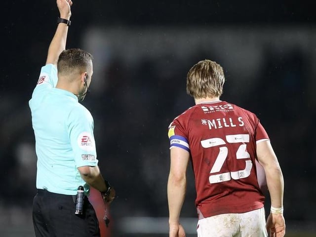 Joseph Mills of Northampton Town is shown a yellow card by referee Paul Howard.
Photo: Getty Images