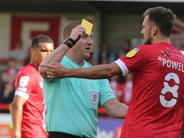 Referee Lee Swabey shows a yellow card to Jack Powell of Crawley Town.
Photo: Getty Images