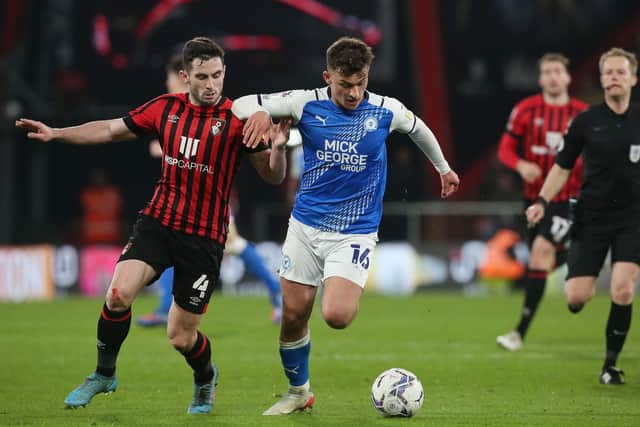 Harrison Burrows of Peterborough United in action with Lewis Cook of Bournemouth. Photo: Joe Dent/theposh.com
