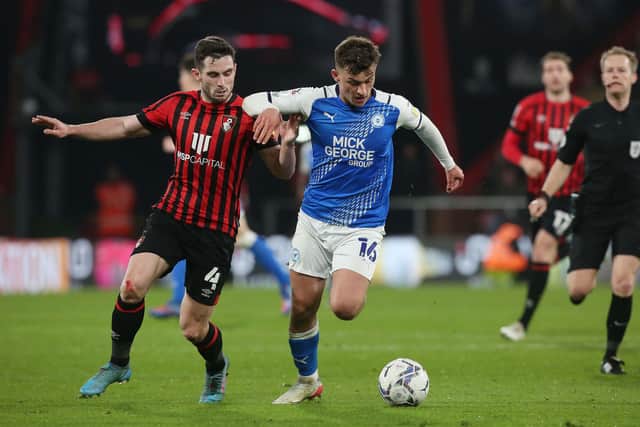 Harrison Burrows of Peterborough United in action with Lewis Cook of Bournemouth. Photo: Joe Dent/theposh.com.