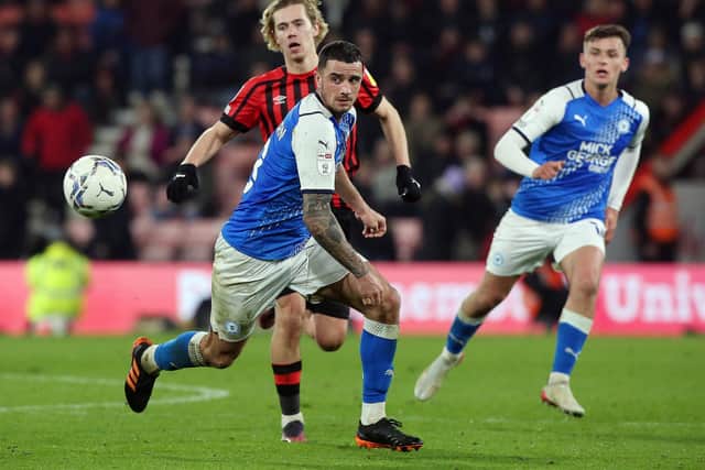 Oliver Norburn of Peterborough United in action with Todd Cantwell of Bournemouth. Photo: Joe Dent/theposh.com.