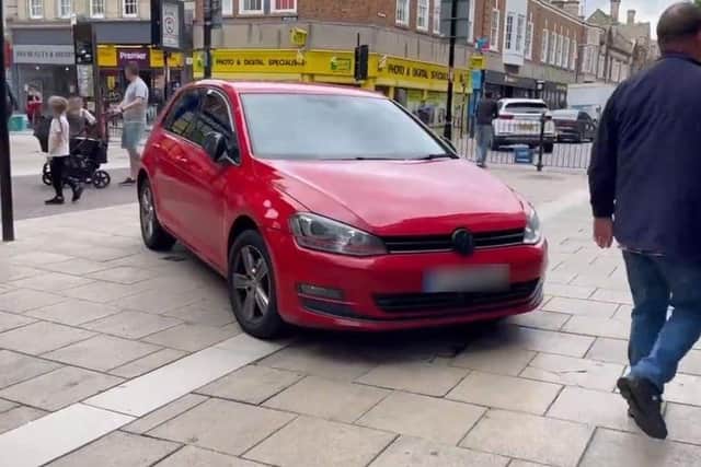 A red Volkswagan parked illegally on Long Causeway in August 2021. Photo: Cllr Wayne Fitzgerald.