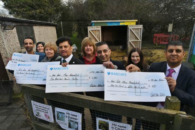 Cllr Shaz Nawaz, Cllr Aasiyah Joseph, Abdul Aziz (Adam's Cash and Carry), Ayaz Nawaz and Tania Chamera  (Blenheim Lettings) and Ansar Ali (Goldstar Taxis) presenting cheques to staff at New Ark Adventure Playground. EMN-220903-165318009