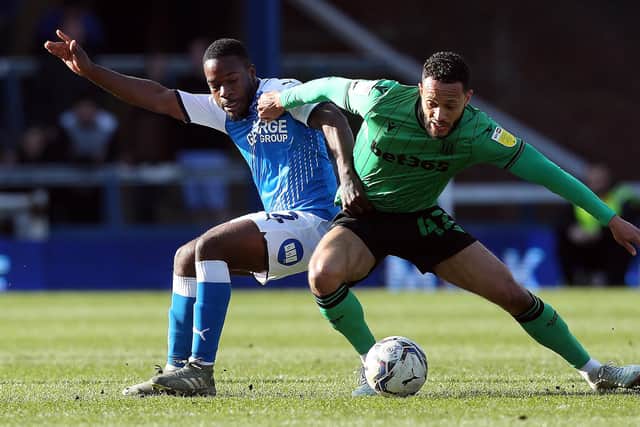 Jeando Fuchs of Peterborough United battles with Lewis Baker of Stoke City. Photo: Joe Dent/theposh.com.