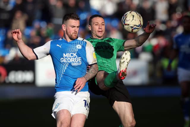 Jack Marriott of Peterborough United battles with James Chester of Stoke City. Photo: Joe Dent/theposh.com.