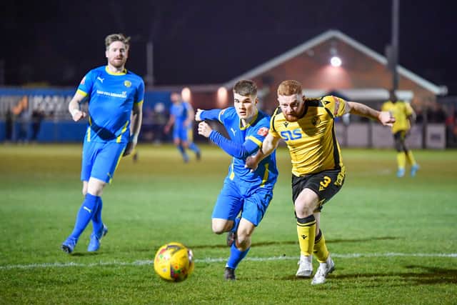 Bradley Rolt (blue) in action for Peterborough Sports against Rushden & Diamonds. Photo: James Richardson.