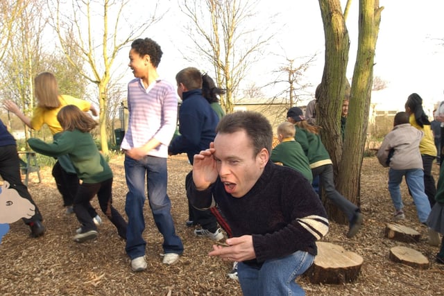 Yaxley based actor Warwick Davies, at the New Ark centre to officially open the new Eco centre (pictured background), plays hide-and -seek in the woodland area with local youngsters.