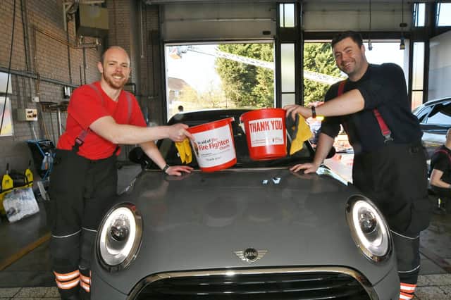 Stanground and Dogsthorpe fire fighters doing their annual charity car wash at Stanground Fire Station. Station Commander Kevin Turner with firefighter Jack Branton EMN-220319-101517009