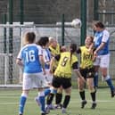 Natalie Hurst of Posh Women outjumps the Leafield Athletic defence. Photo: Gary Reed.