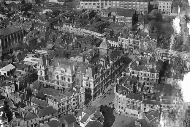 Here is one of the earliest aerial photographs on the Aerial Photograph Explorer of  Ipswich Town Hall and Corn Exchange taken sometime in 1921. The Town Hall, which was built in 1867-68, is the large building with the clock tower and is a good example of high Victorian civic architecture. The Corn Exchange, built in 1878-82, is the large stone fronted building in the centre of the photograph. (Photo: Historic England)