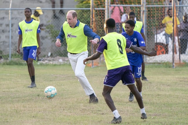 The Duke of Cambridge joins young footballers on the football pitch during a visit to Trenchtown in Kingston, Jamaica, on day four of their tour of the Caribbean on behalf of the Queen to mark her Platinum Jubilee. Picture date: Tuesday March 22, 2022. EMN-220323-131313005