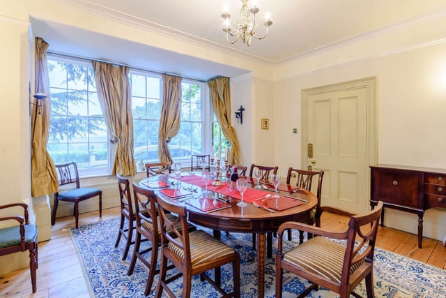 The dining room has original solid wood floorboards and deep skirting boards.