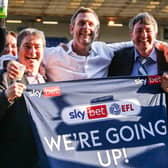 Posh co-owners, from left, Stewart Thompson, Darragh MacAnthony and Jason Neale celebrate promotion from League One in May, 2021.
