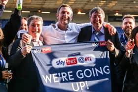 Posh co-owners, from left, Stewart Thompson, Darragh MacAnthony and Jason Neale celebrate promotion from League One in May, 2021.