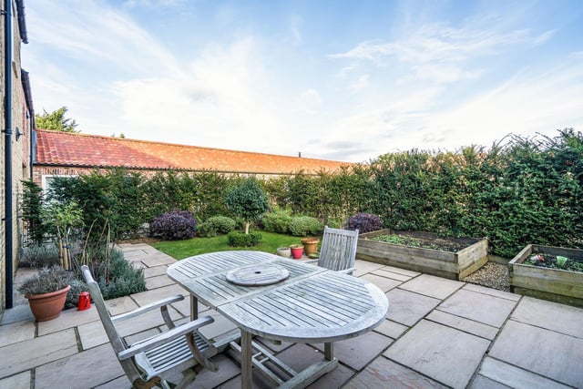 The barn conversion is set in landscaped gardens with impressive views overlooking the garden from the property's feature windows.