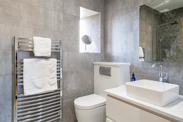 There is a separate main bedroom suite on the opposite side of the house - which has a built-in closet and this en suite shower room.