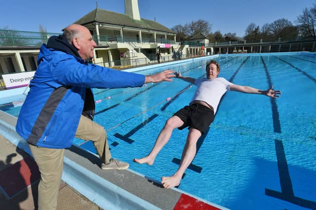 Opening of the Lido - FIRST in the pool this season MP for Peterborough Paul Bristow - pushed in by Lido opening day ever-present John Peach EMN-220204-104026009