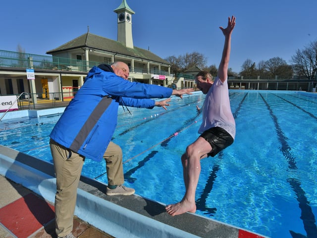 Opening of the Lido - FIRST in the pool this season MP for Peterborough Paul Bristow - pushed in by Lido opening day ever-present John Peach EMN-220204-104047009