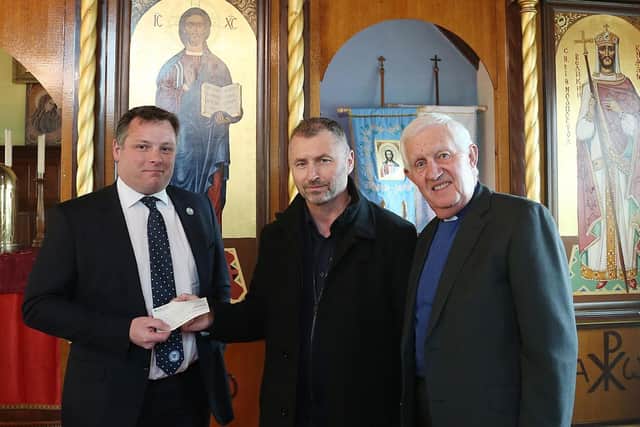 Chief Executive David Paton hands over the cheque to St Olga Ukrainian Church in Woodston.